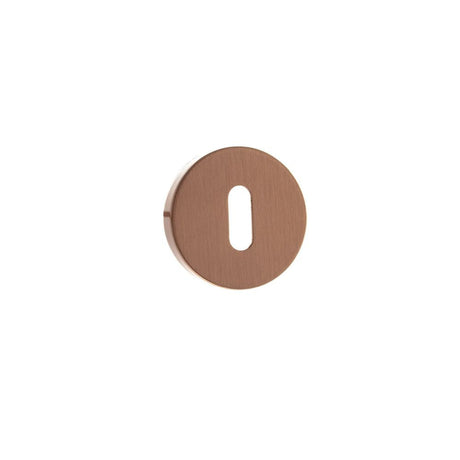 This is an image of Forme Key Escutcheon on Minimal Round Rose - Urban Satin Copper available to order from T.H Wiggans Architectural Ironmongery in Kendal, quick delivery and discounted prices.