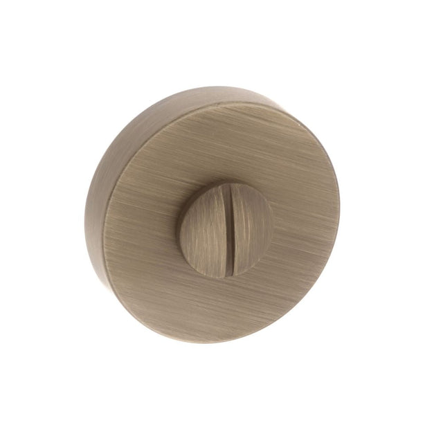 This is an image of Forme WC Turn and Release on Minimal Round Rose - Yester Bronze available to order from T.H Wiggans Architectural Ironmongery in Kendal, quick delivery and discounted prices.