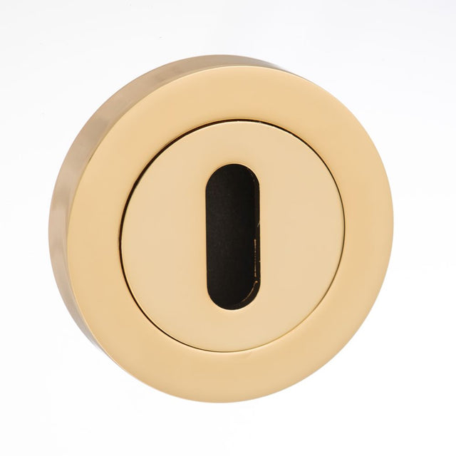 This is an image of Mediterranean Key Escutcheon on Round Rose - Polished Brass available to order from T.H Wiggans Architectural Ironmongery in Kendal, quick delivery and discounted prices.