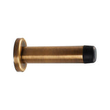 This is an image of Carlisle Brass - Cylinder Pattern Door Stop - with Rose - Antique Brass available to order from T.H Wiggans Architectural Ironmongery in Kendal, quick delivery and discounted prices.