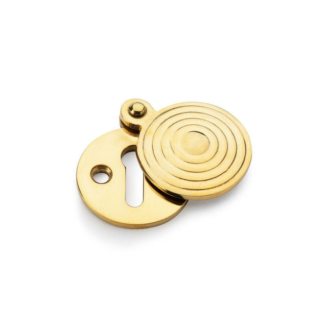 This is an image showing Alexander & Wilks Standard Key Profile Round Escutcheon with Christoph Design Cover - Unlacquered Brass aw382-ub available to order from T.H Wiggans Ironmongery in Kendal, quick delivery and discounted prices.