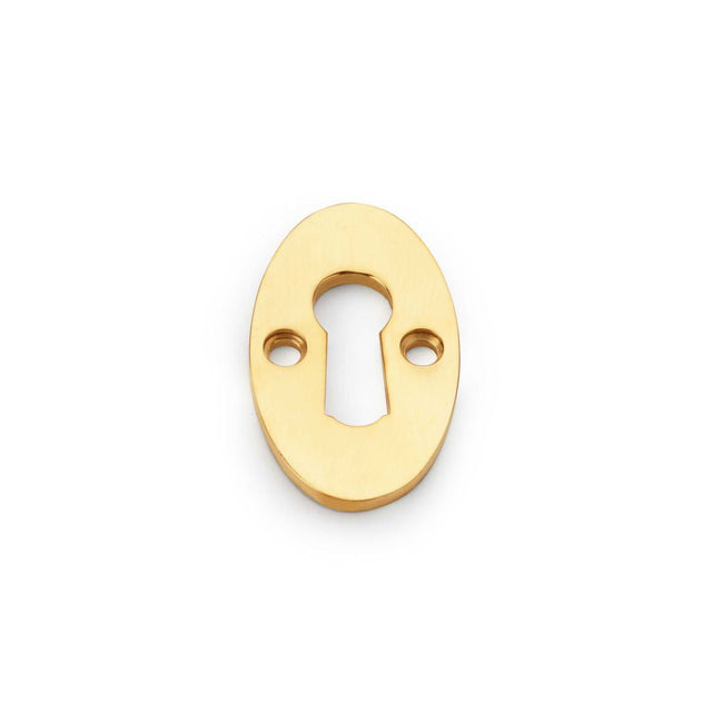 This is an image showing Alexander & Wilks Standard Key Profile Ellipse Escutcheon - Unlacquered Brass aw383-ub available to order from T.H Wiggans Ironmongery in Kendal, quick delivery and discounted prices.