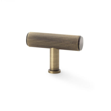 This is an image showing Alexander & Wilks Crispin Reeded T-bar Cupboard Knob - Antique Brass aw801r-55-ab available to order from T.H Wiggans Ironmongery in Kendal, quick delivery and discounted prices.