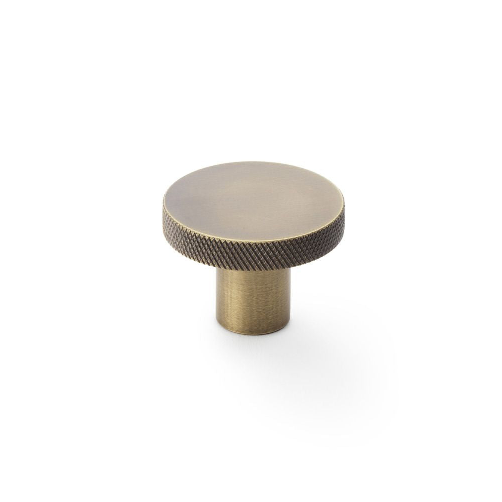 This is an image showing Alexander & Wilks Hanover Knurled Circular Cupboard Knob - Antique Brass - 38mm aw802-38-ab available to order from T.H Wiggans Ironmongery in Kendal, quick delivery and discounted prices.