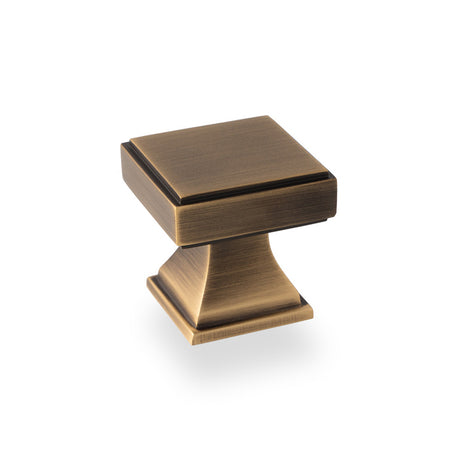 This is an image showing Alexander & Wilks Jesper Square Cupboard Knob - Antique Brass aw806-30-ab available to order from T.H Wiggans Ironmongery in Kendal, quick delivery and discounted prices.