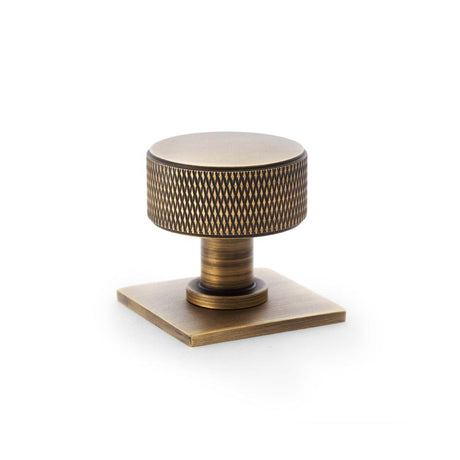 This is an image showing Alexander & Wilks Lucia Knurled Cupboard Knob - Antique Brass - 35mm aw807k-35-ab available to order from T.H Wiggans Ironmongery in Kendal, quick delivery and discounted prices.