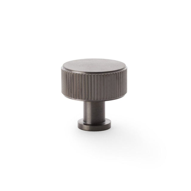 This is an image showing Alexander & Wilks Lucia Reeded Cupboard Knob - Dark Bronze PVD - 35mm aw807r-35-dbzpvd available to order from T.H Wiggans Ironmongery in Kendal, quick delivery and discounted prices.