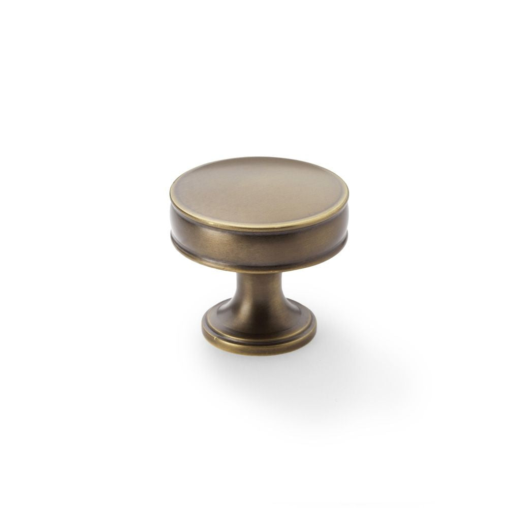 This is an image showing Alexander & Wilks Lynd Cupboard Knob - Antique Brass - 38mm aw808-38-ab available to order from T.H Wiggans Ironmongery in Kendal, quick delivery and discounted prices.