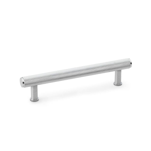 This is an image showing Alexander & Wilks Crispin Knurled T-bar Cupboard Pull Handle - Satin Chrome - Centres 128mm aw809-128-sc available to order from T.H Wiggans Ironmongery in Kendal, quick delivery and discounted prices.