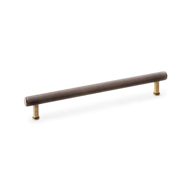 This is an image showing Alexander & Wilks Crispin Knurled T-bar Cupboard Pull Handle - Antique Brass - Centres 224mm aw809-224-ab available to order from T.H Wiggans Ironmongery in Kendal, quick delivery and discounted prices.