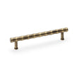 This is an image showing Alexander & Wilks Crispin Bamboo T-bar Cupboard Pull Handle - Antique Brass aw809b-160-ab available to order from T.H Wiggans Ironmongery in Kendal, quick delivery and discounted prices.