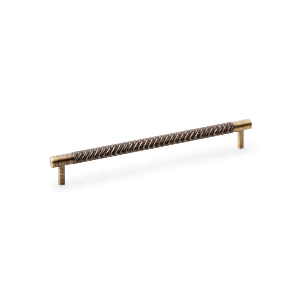 This is an image showing Alexander & Wilks Brunel Knurled T-Bar Cupboard Handle - Antique Brass - Centres 224mm aw810-224-ab available to order from T.H Wiggans Ironmongery in Kendal, quick delivery and discounted prices.