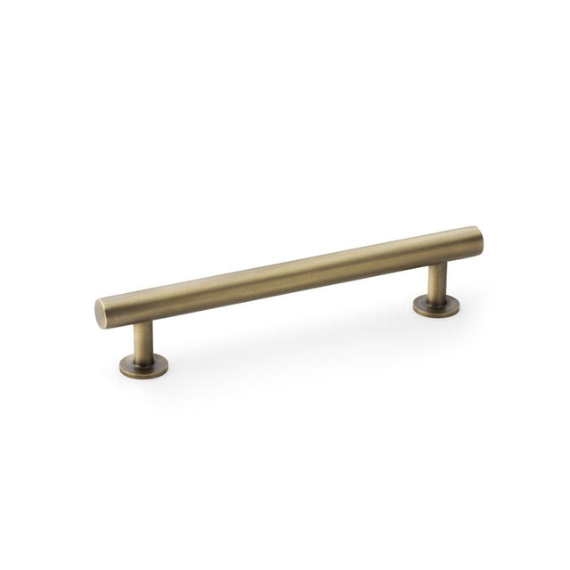 This is an image showing Alexander & Wilks Round T-Bar Cabinet Pull Handle - Antique Brass - Centres 128mm aw814-128-ab available to order from T.H Wiggans Ironmongery in Kendal, quick delivery and discounted prices.