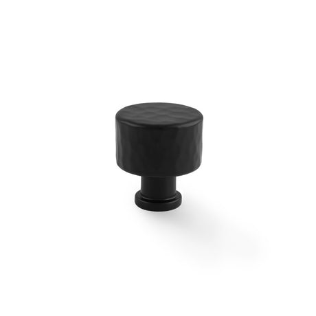 This is an image showing Alexander & Wilks Leila - Hammered Cupboard Knob - Black - 30mm aw816-30-bl available to order from T.H Wiggans Ironmongery in Kendal, quick delivery and discounted prices.