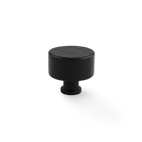 This is an image showing Alexander & Wilks Leila Hammered Cupboard Knob - Black - 35mm aw816-35-bl available to order from T.H Wiggans Ironmongery in Kendal, quick delivery and discounted prices.