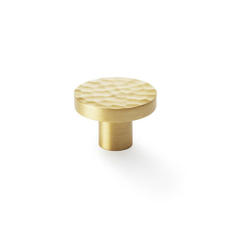 This is an image showing Alexander & Wilks Hanover Hammered Cupboard Knob - Satin Brass - 38mm aw820-38-sb available to order from T.H Wiggans Ironmongery in Kendal, quick delivery and discounted prices.