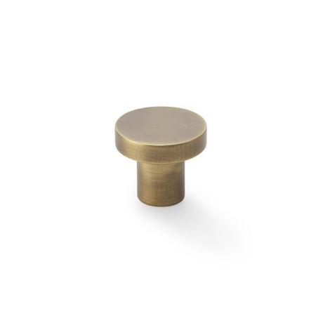 This is an image showing Alexander & Wilks Hanover Plain Cupboard Knob - Antique Brass - Knob 30mm aw821-30-ab available to order from T.H Wiggans Ironmongery in Kendal, quick delivery and discounted prices.