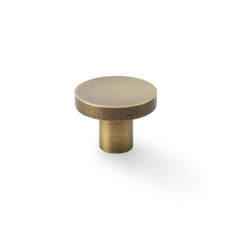 This is an image showing Alexander & Wilks Hanover Plain Cupboard Knob - Antique Brass - Knob 38mm aw821-38-ab available to order from T.H Wiggans Ironmongery in Kendal, quick delivery and discounted prices.