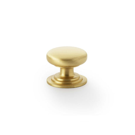 This is an image showing Alexander & Wilks Waltz Round Cupboard Knob on Stepped Rose - Satin Brass - 32mm aw825-32-sb available to order from T.H Wiggans Ironmongery in Kendal, quick delivery and discounted prices.