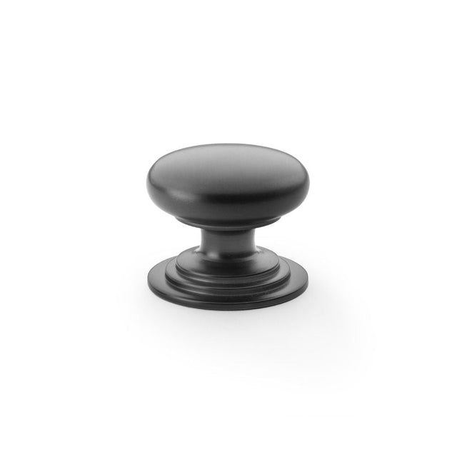 This is an image showing Alexander & Wilks Waltz Round Cupboard Knob on Stepped Rose - Black - 38mm aw825-38-bl available to order from T.H Wiggans Ironmongery in Kendal, quick delivery and discounted prices.