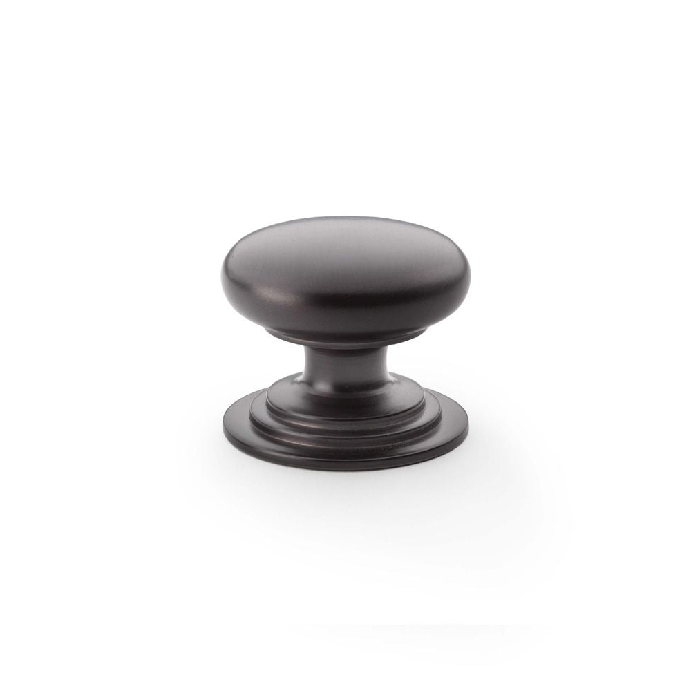 This is an image showing Alexander & Wilks Waltz Round Cupboard Knob on Stepped Rose - Dark Bronze - 38mm aw825-38-dbz available to order from T.H Wiggans Ironmongery in Kendal, quick delivery and discounted prices.