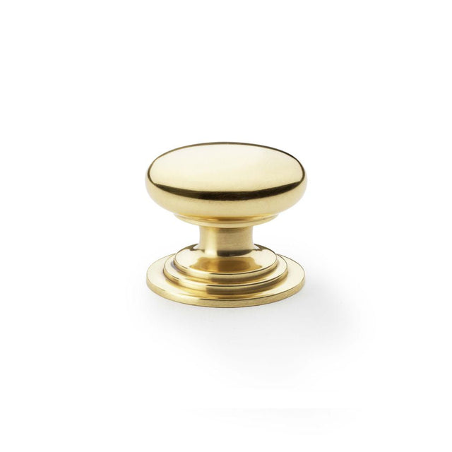 This is an image showing Alexander & Wilks Waltz Round Cupboard Knob on Stepped Rose - Polished Brass - 38mm aw825-38-pbl available to order from T.H Wiggans Ironmongery in Kendal, quick delivery and discounted prices.