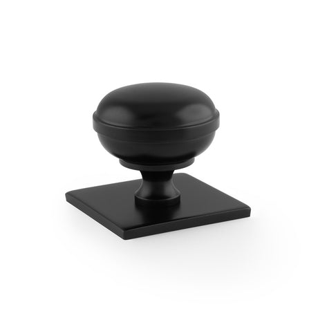 This is an image showing Alexander & Wilks Quantock Cupboard Knob on Square Backplate - Black - 34mm aw826-34-bl available to order from T.H Wiggans Ironmongery in Kendal, quick delivery and discounted prices.