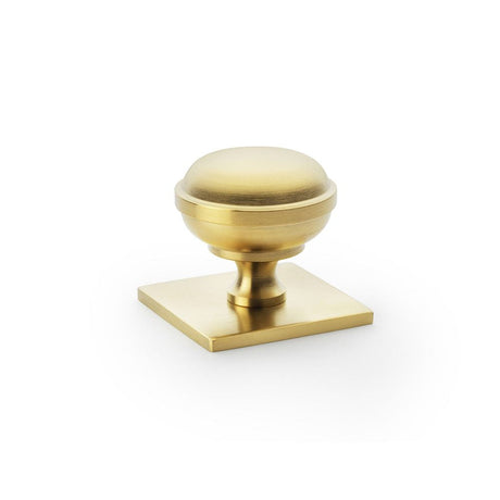 This is an image showing Alexander & Wilks Quantock Cupboard Knob on Square Backplate - Satin Brass PVD - 34mm aw826-34-sbpvd available to order from T.H Wiggans Ironmongery in Kendal, quick delivery and discounted prices.