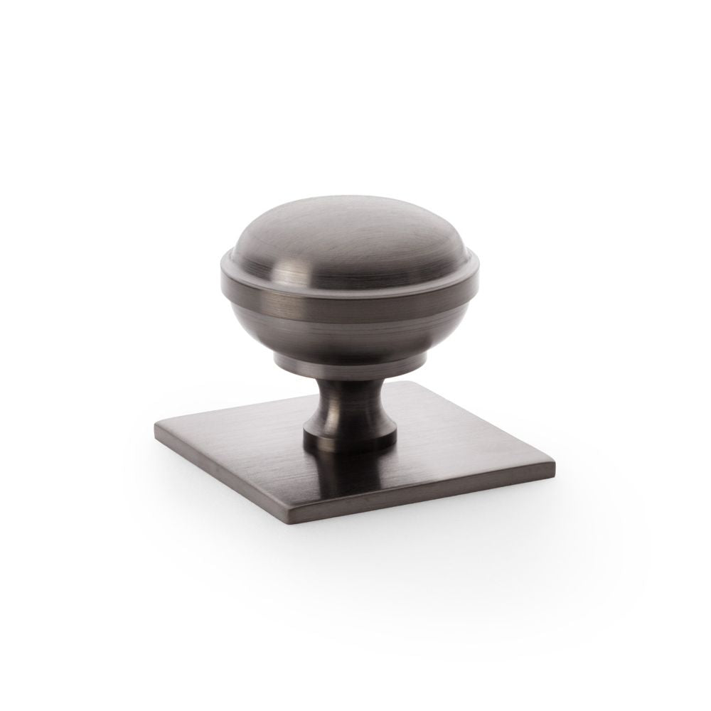 This is an image showing Alexander & Wilks Quantock Cupboard Knob on Square Backplate - Dark Bronze PVD - 38mm aw826-38-dbzpvd available to order from T.H Wiggans Ironmongery in Kendal, quick delivery and discounted prices.