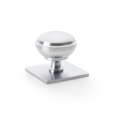 This is an image showing Alexander & Wilks Quantock Cupboard Knob on Square Backplate - Satin Chrome - 38mm aw826-38-sc available to order from T.H Wiggans Ironmongery in Kendal, quick delivery and discounted prices.