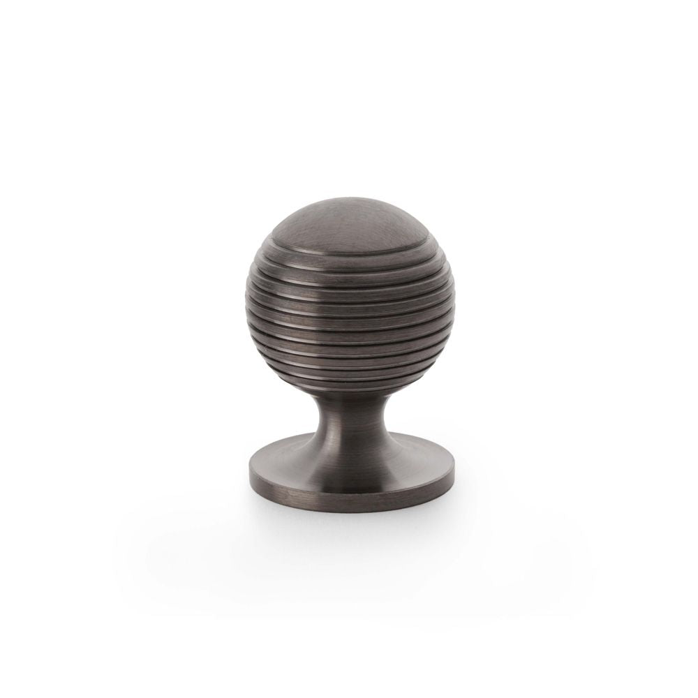 This is an image showing Alexander & Wilks Caesar Cupboard Knob on Round Rose - Dark Bronze PVD - 32mm aw832-32-dbzpvd available to order from T.H Wiggans Ironmongery in Kendal, quick delivery and discounted prices.