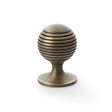 This is an image showing Alexander & Wilks Caesar Cupboard Knob on Round Rose - Antique Brass - 38mm aw832-38-ab available to order from T.H Wiggans Ironmongery in Kendal, quick delivery and discounted prices.