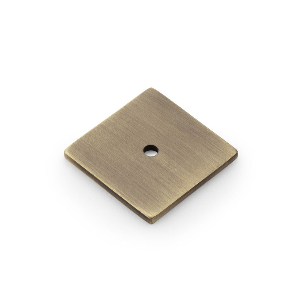 This is an image showing Alexander & Wilks Quantock Square Backplate - Antique Brass aw893-38-ab available to order from T.H Wiggans Ironmongery in Kendal, quick delivery and discounted prices.