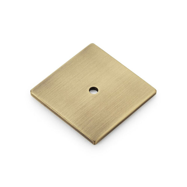 This is an image showing Alexander & Wilks Bullion Square Backplate - Antique Brass aw894-45-ab available to order from T.H Wiggans Ironmongery in Kendal, quick delivery and discounted prices.