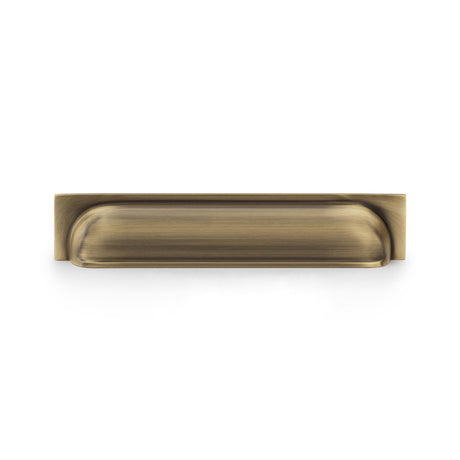 This is an image showing Alexander & Wilks Quantock Cup Pull Handle - Antique Brass - Centres 203mm aw906ab available to order from T.H Wiggans Ironmongery in Kendal, quick delivery and discounted prices.