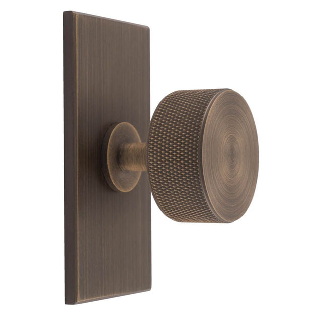 This is an image of a Carlisle Brass - Knurled Radio Knob on Backplate that is availble to order from T.H Wiggans Architectural Ironmongery in Kendal in Kendal.