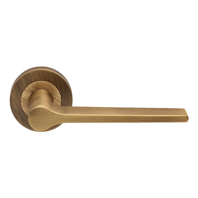 This is an image of Carlisle Brass - Velino Lever on Round Rose - Antique Brass available to order from T.H Wiggans Architectural Ironmongery in Kendal, quick delivery and discounted prices.