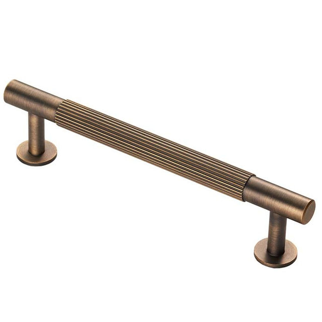 This is an image of a Carlisle Brass - Lines Pull Handle 128mm c/c - Antique Brass that is availble to order from T.H Wiggans Architectural Ironmongery in Kendal in Kendal.