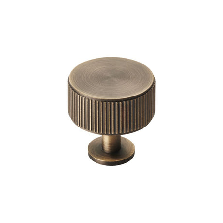 This is an image of a Carlisle Brass - Lines Radio Knob - Antique Brass that is availble to order from T.H Wiggans Architectural Ironmongery in Kendal in Kendal.