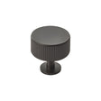 This is an image of a Carlisle Brass - Lines Radio Knob - Matt Black that is availble to order from T.H Wiggans Architectural Ironmongery in Kendal in Kendal.