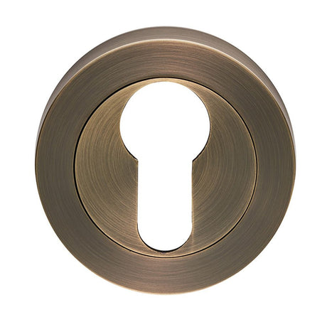 This is an image of Carlisle Brass - Euro Profile escutcheon - Antique Brass available to order from T.H Wiggans Architectural Ironmongery in Kendal, quick delivery and discounted prices.