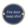 This is an image showing the Frelan - Fire Door Keep Shut' - Signage 75mm Dia. - Polished Stainless Steel available to order from T.H. Wiggans Ironmongery in Kendal