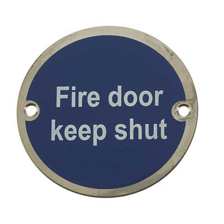 This is an image showing the Frelan - Fire Door Keep Shut' - Signage 75mm Dia. - Polished Stainless Steel available to order from T.H. Wiggans Ironmongery in Kendal