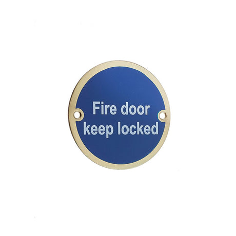 This is an image showing the Frelan - Fire Door Keep Locked' - Signage 75mm Dia. - Polished Brass available to order from T.H. Wiggans Ironmongery in Kendal