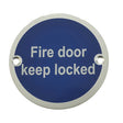 This is an image showing the Frelan - Fire Door Keep Locked' - Signage 75mm Dia. - Satin Anodised Aluminium available to order from T.H. Wiggans Ironmongery in Kendal