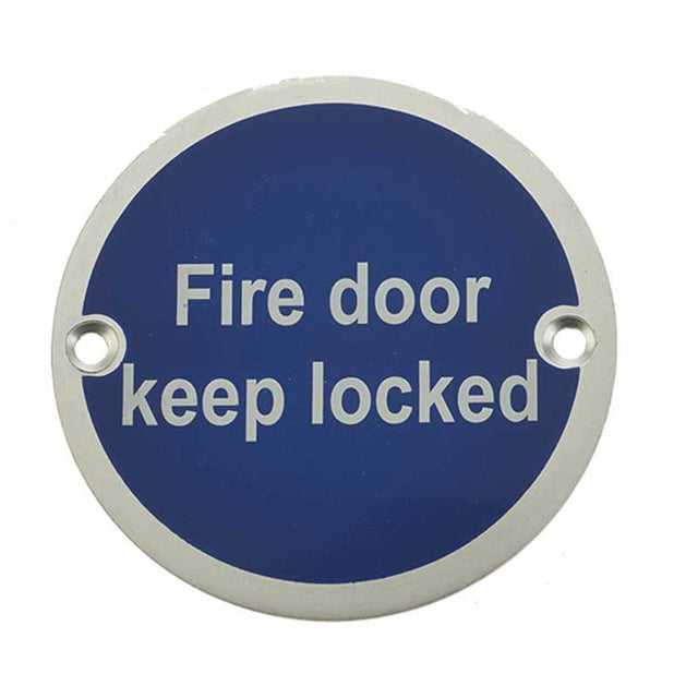 This is an image showing the Frelan - Fire Door Keep Locked' - Signage 75mm Dia. - Satin Anodised Aluminium available to order from T.H. Wiggans Ironmongery in Kendal