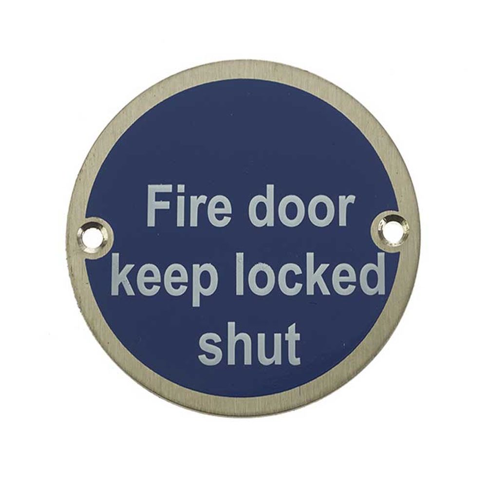 This is an image showing the Frelan - Fire Door Keep Locked Shut - Signage 75mm Dia. - Satin Stainless Steel available to order from T.H. Wiggans Ironmongery in Kendal