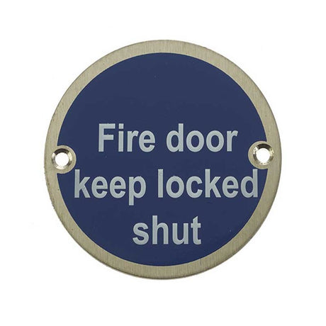 This is an image showing the Frelan - Fire Door Keep Locked Shut - Signage 75mm Dia. - Satin Stainless Steel available to order from T.H. Wiggans Ironmongery in Kendal