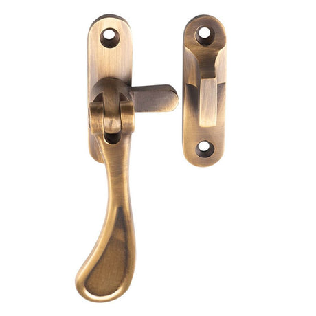 This is an image of a Carlisle Brass - Casement Fastener Reversible - Antique Brass that is availble to order from T.H Wiggans Architectural Ironmongery in Kendal in Kendal.