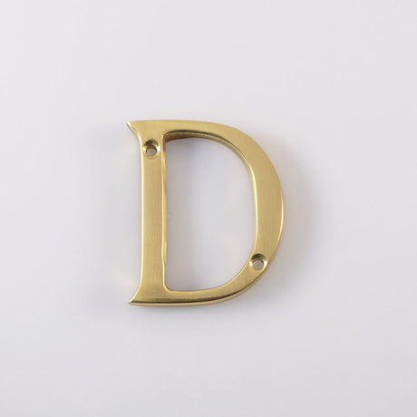 This is an image of Carlisle Brass - Letter D - Polished Brass available to order from T.H Wiggans Architectural Ironmongery in Kendal, quick delivery and discounted prices.